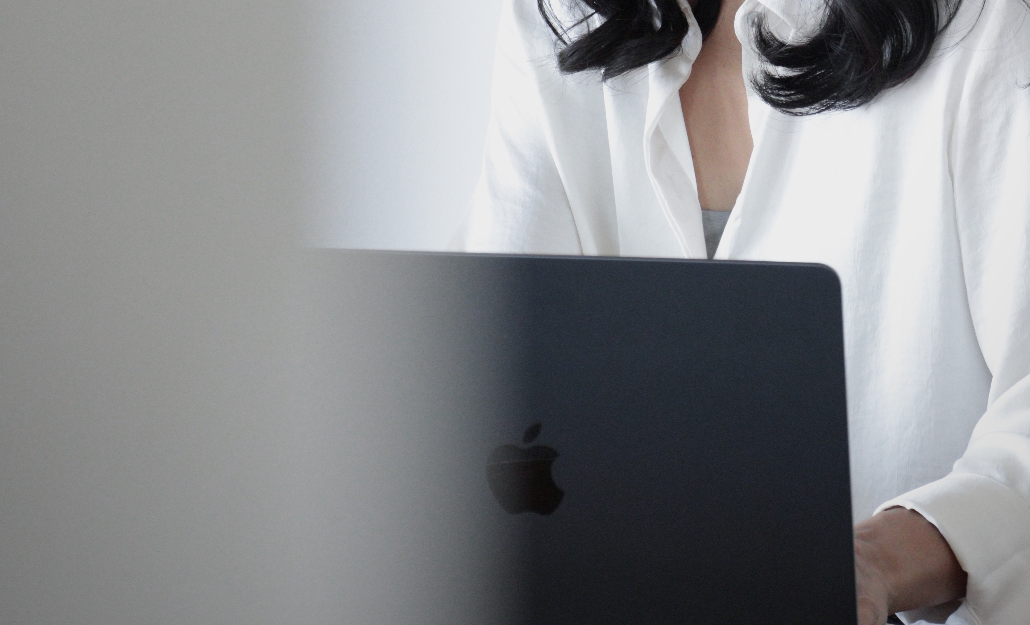 Hands resting on a laptop